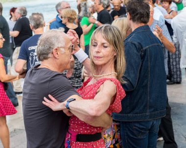 Paris'teki Seine Nehri'nin kıyısında dans eden yaşlı insanlar. 10 Ağustos 2019 Paris, Fransa. 