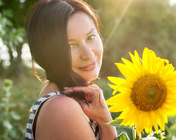 Woman and sunflower. Ukraine. July 21, 2019