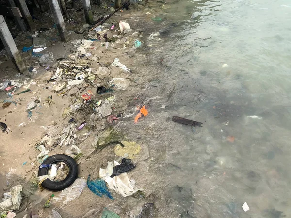 Pollution in the sea around Sri Ban Phe Pier in Thailand