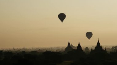 Bagan, Myanmar, Burma 'daki Pagodas' ın üzerinde gün doğumunda uçan balonlar.