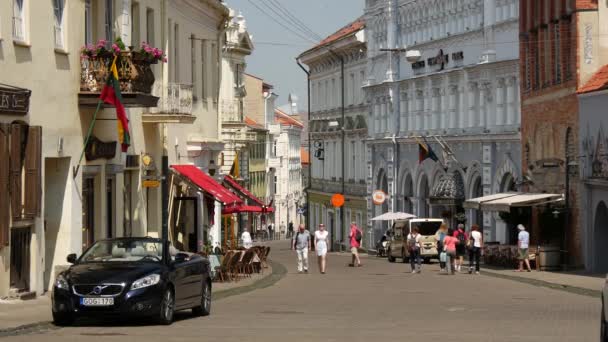 在立陶宛维尔纽斯老城 人们在街上散步时听到教堂的钟声 — 图库视频影像