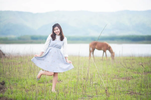 亚洲女孩的画像在美丽的地区和马背景旅行 — 图库照片