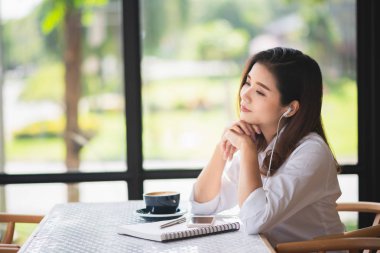 güzel kız kafede müzik dinlemek ve kahve içmek