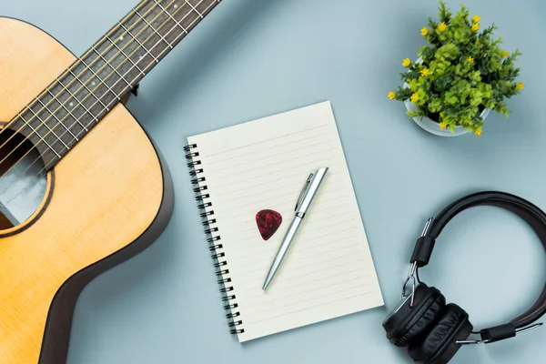 Top view guitarra y libreta de notas y auriculares, concepto de música — Foto de Stock