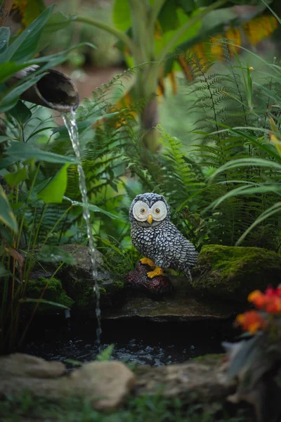close up of owl statue in the garden