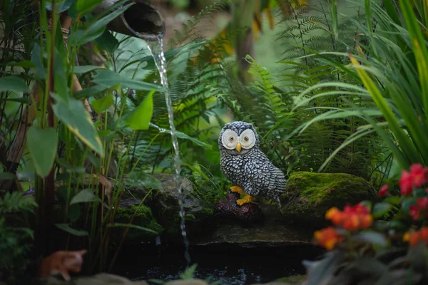 close up of owl statue in the garden