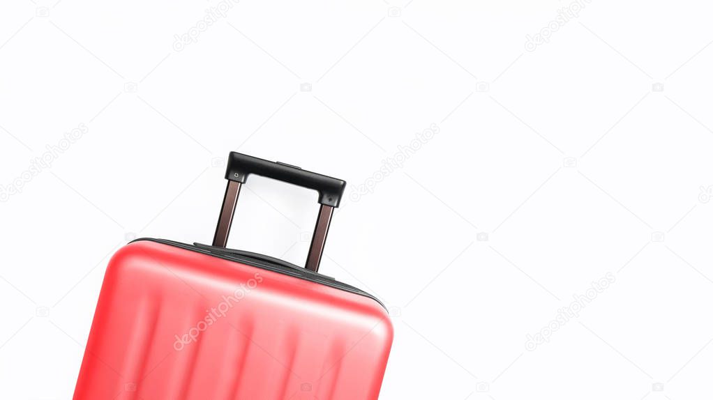 Suitcase on light red background with place for text. Minimal creative travel concept