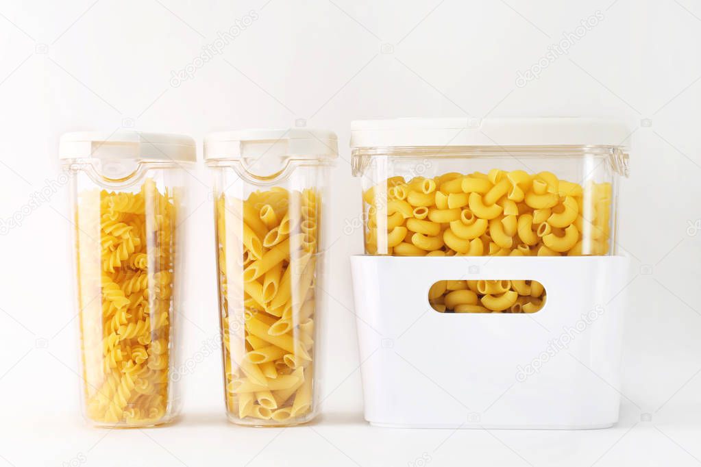 Photo of different types of pasta in containers on white background.