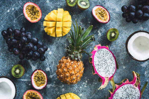 Tropical fruits, exotic fruits on concrete background. Flat lay