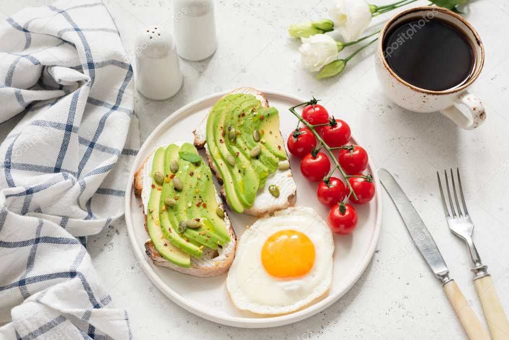 Breakfast with avocado toast, egg and coffee