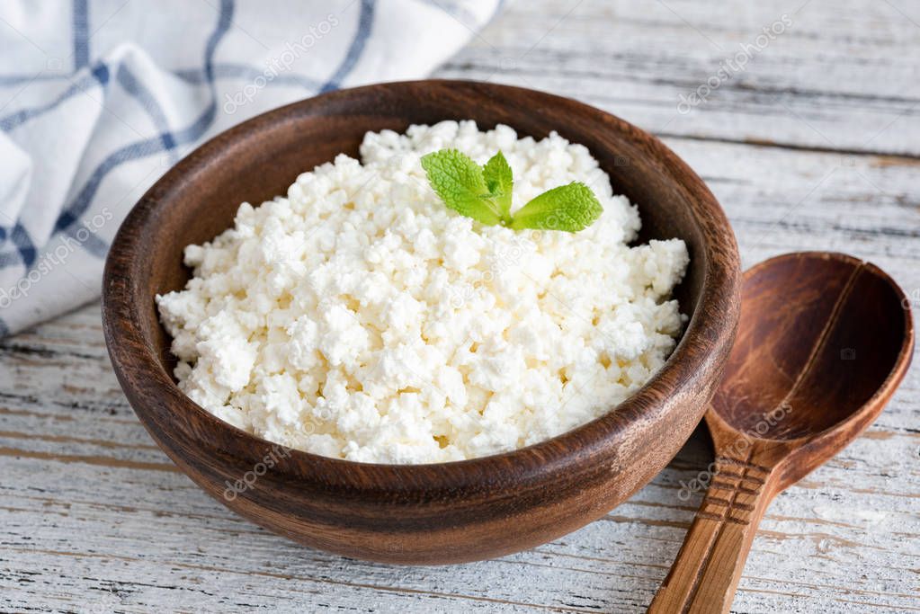 Cottage cheese, ricotta or tvorog in wooden bowl