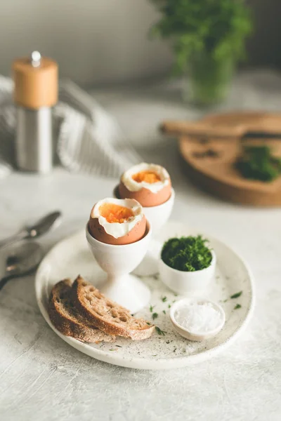 Boiled eggs in egg cups for breakfast — Stock Photo, Image