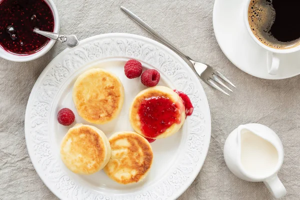 Cottage cheese pancakes with jam and coffee