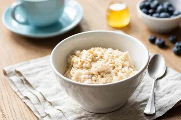 Oatmeal porridge, scottish oats in a bowl — Stock Photo, Image