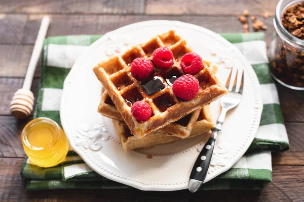 Belgian waffles with raspberries and honey