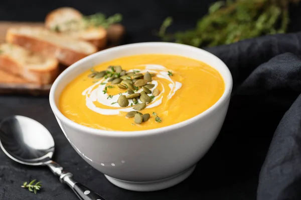 Pumpkin cream soup with pumpkin seeds and cream