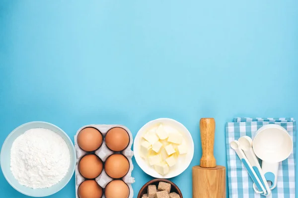 Ingredients for baking or cooking on blue background