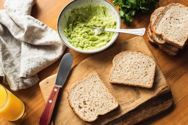 Sandviç ekmeği ve masada püresi avokado