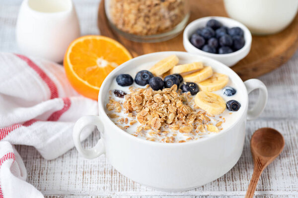 Breakfast granola bowl with banana and blueberries