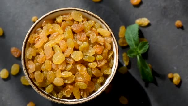 Golden Raisins Bowl Black Concrete Backdrop Table Top View Footage — Stock Video