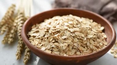 Kaseye düşen yulaf veya yulaf gevreği yavaş hareket. Sağlıklı gıda, sağlıklı beslenme, tarım hasat kavramı