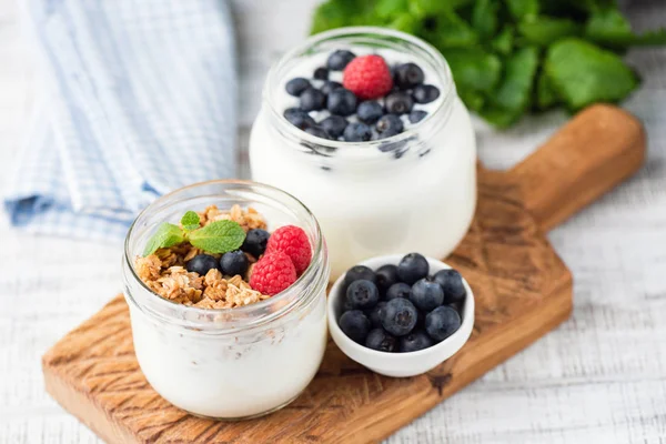 Greek yogurt topped with granola and berries