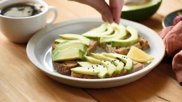 Healthy Avocado Toast Breakfast Female Hands Seasoning Avocado Sandwich Black — Stock Video