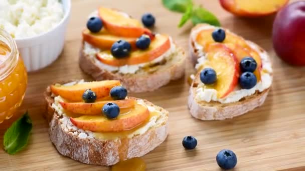 Tasty Fruit Bruschetta Ricotta Cheese Peach Blueberries Honey Wooden Serving — Stock Video
