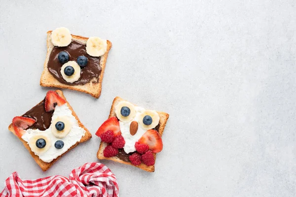 Funny Healthy Breakfast Toasts For Kids Shaped As Cute Animals On Grey Concrete Background With Copy Space For Text. Children\'s Food Menu For School Lunch Box Or Breakfast At Home. Motherhood Concept