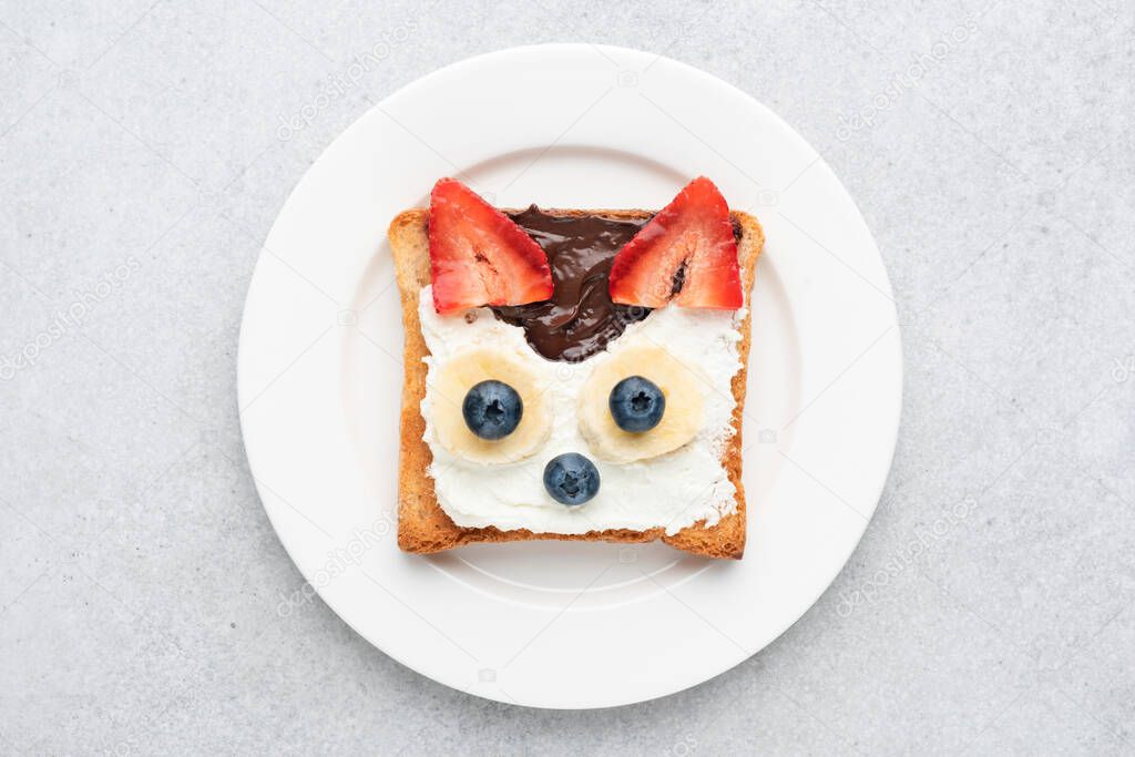 Funny breakfast toast for kids shaped as cute cat