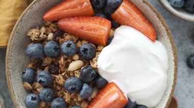 Böğürtlenli granola ve kase içinde Yunan yoğurdu. Kahvaltı veya atıştırmalık sağlıklı yiyecekler.