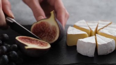 Taze mor incir dilimleme ve camembert peyniri. Meyveli peynir tabağı, aperatif.