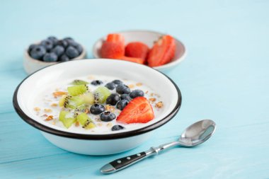 Badem sütü, meyve ve granola ile kahvaltı kasesi.