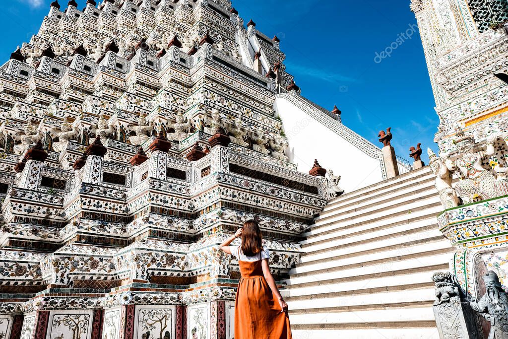 Brown skirt girl With the Prang of Arun Temple, Wat arun Bangkok Thailand.