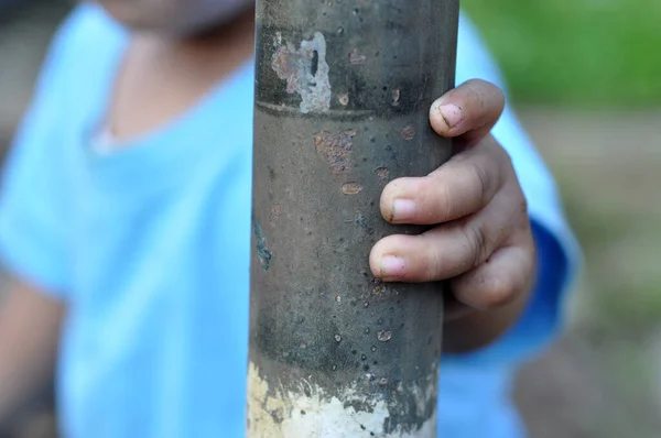 Toddler Holding Iron Pole — Stock Photo, Image