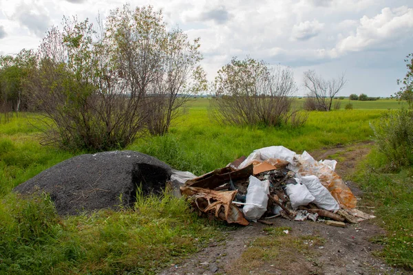 Unauthorized landfills - environmental pollution. Unauthorized landfills - environmental pollution. Illegal dump at the edge of the forest, discarded rubbish.