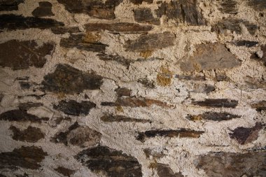 Eine alte Steinwand von einem ve Bauernhof.