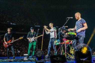 Coldplay performing on stage during  music festival 