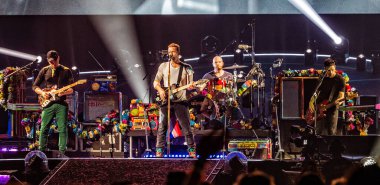 Coldplay performing on stage during  music festival 