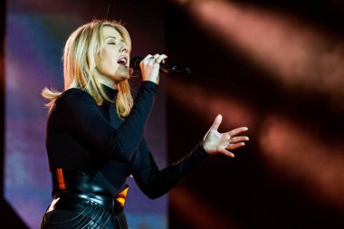 Ellie Goulding performing on stage during  music festival clipart