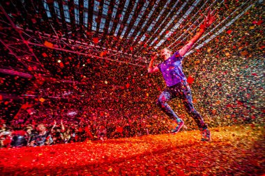 Coldplay performing on stage during  music festival 