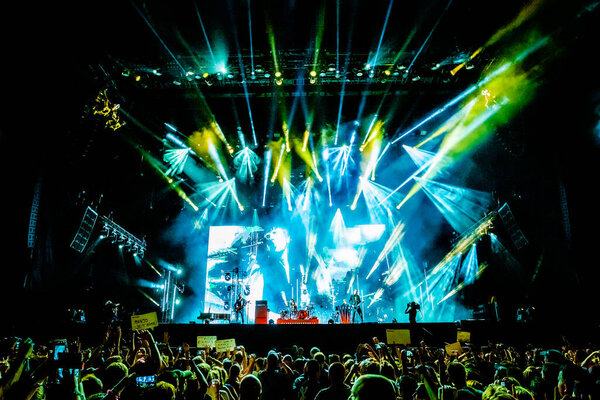 Muse performing on stage during  music festival