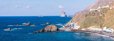 rocky ocean coast in Tenerife, panorama. The town of Taganana clipart
