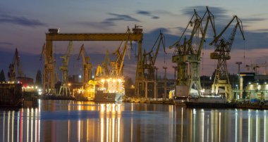 industrial areas, shipyard and port after sunset - Szczecin, Poland clipart
