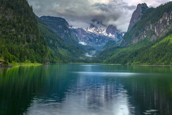 majestic storm clouds over peaks of mountains, lake Gosausee, Austia