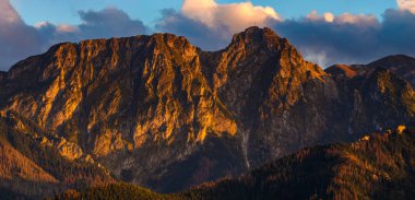 scenic view of Giewont Mountain in Tatras in rays of setting sun clipart