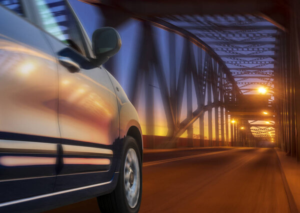 car driving at high speed at night through a truss bridge