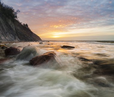 a spectacular, dynamic sunset around the cliffs in Wolin national park in Poland clipart