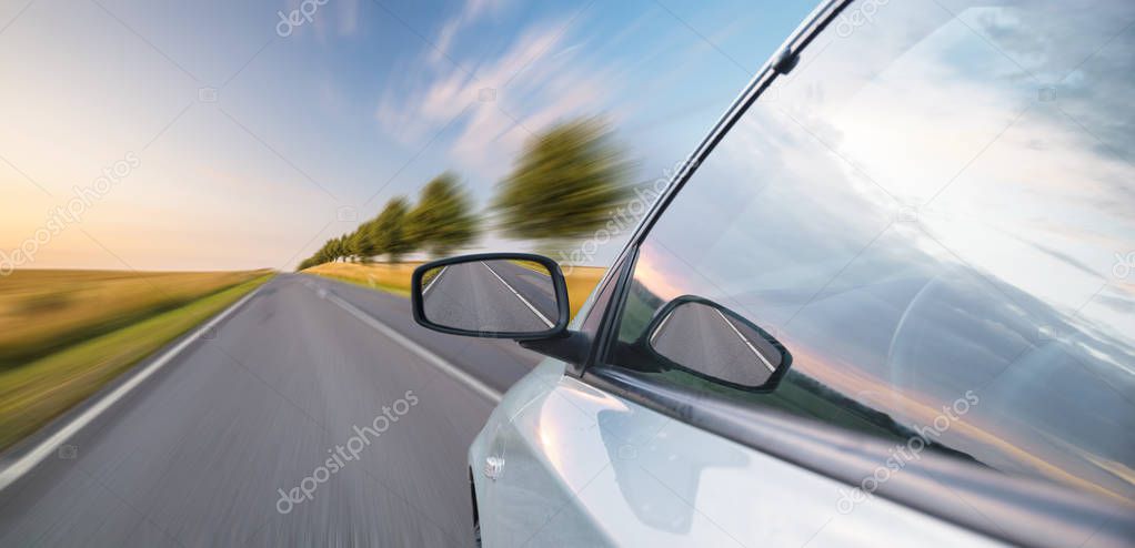 A view of a car passing by the road