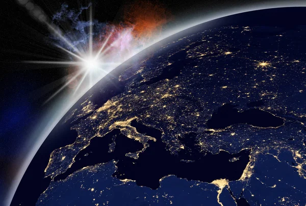 vision of sunrise over the earth visible from space. city lights visible on the continents.